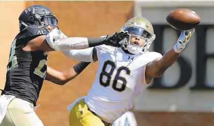  ?? STREETER LECKA/GETTY IMAGES ?? Justin Strnad, left, of Wake Forest breaks up a pass intedned for Alize Mack of Notre Dame during the Irish’s 56-27 victory in Winston Salem, N.C.