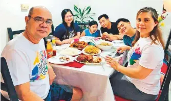  ??  ?? ■
Mary Kim (second from left) with her husband, two children and parents. “We were able to eat at one table after almost two months of isolation in separate rooms,” she said.