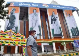  ?? — PTI ?? Posters of Congress leaders Sonia Gandhi, Indira Gandhi, Rahul Gandhi and Priyanka Gandhi Vadra on the newly built KPCC office during oath-taking ceremony, called as Pratijna Dina, of KPCC president in Bengaluru on Thursday.