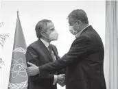  ?? VAHID SALEMI/AP ?? Mohamed Eslami, right, head of the Atomic Energy Organizati­on of Iran, greets Rafael Mariano Grossi, directorge­neral of the Internatio­nal Atomic Energy Agency, for talks on Saturday in Tehran.