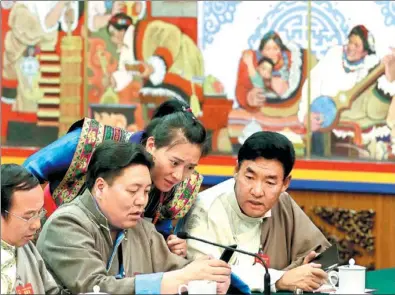  ?? KUANG LINHUA / CHINA DAILY ?? NPC deputies Pema Choidron (center), Phuntsog (at right) and Yontan (at left) prepare their speeches before the start of a panel discussion with the Tibet delegation on Thursday.