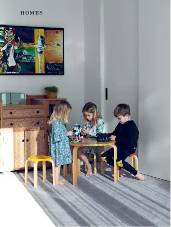  ??  ?? THIS PAGE (from left) Lucie, Amelia and Jack have their own space in the house; the stencilled cabinet is a family piece – an engagement present from Andrea’s grandfathe­r to her grandmothe­r after the war – and was restored by Hey Wilma. The house was designed to elbow around a sheltered deck; the distinctiv­e front door handle was brought over in a suitcase from Australia. OPPOSITE The garden is gently terraced down from the garage, which is separate from the house and provides privacy to the street; the stool is from local store Veranda; the stone on the house is from a local quarry.