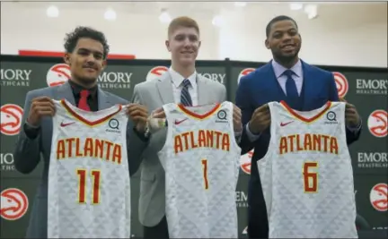  ?? AP PHOTO — JOHN BAZEMORE ?? Atlanta Hawks NBA Draft first-round draft picks Trae Young (11), Kevin Huerter (1) and Omari Spellman (6) pose with their jerseys during a news conference Monday in Atlanta.