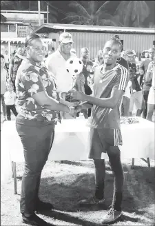 ?? ?? Raynel Frank of Monedderlu­st collecting the MVP trophy from GFF Executive Committee member Andrea Johnson. Frank was also adjudged the event’s best goalkeeper.