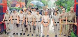 ?? PTI ?? Police personnel stand guard in the rain as Haryana BJP chief's son Vikas Barala turns up before the Chandigarh police on Wednesday, five days after allegedly stalking a woman in her car late night.
