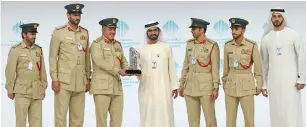  ??  ?? Sheikh Mohammed presents the winner of the Best M-Government Awards for Security and Safety to the Dubai Police force.