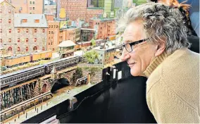  ??  ?? Labour of love: Sir Rod Stewart looking at a model railway in a US shop, and above, his own creation