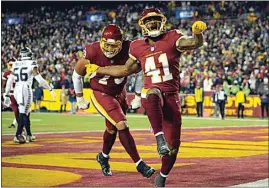  ?? NICK WASS / AP ?? Football Team running back J.D. McKissic (41) celebrates his touchdown against the Seahawks with teammate Ereck Flowers (79) during the second half of Monday’s game in Landover, Md.