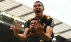  ??  ?? Adama Traoré gives Conor Coady a lift after scoring the first of his two goals for Wolves at Manchester City. Photograph: Sam Bagnall - AMA/Getty Images