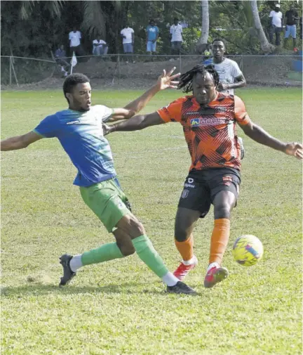  ?? (Photo: Paul Reid) ?? Montego Bay United’s Renaldo Wellington (left) challenges Rodico Wellington of Tivoli Gardens in the Jamaica Premier League football match at Wespow Park in St James on Sunday.