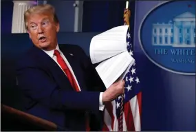  ?? (AP File) ?? Then-President Donald Trump holds up papers in April 2020.