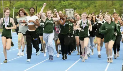  ?? AUSTIN HERTZOG - MEDIANEWS GROUP ?? The Methacton girls track and field team takes a victory lap after winning the team title at the PAC Track and Field Championsh­ips Saturday at Norristown.