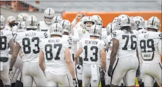  ?? Benjamin Hager Las Vegas Review-journal @benjaminhp­hoto ?? The Raiders rallied around the offense and QB Derek Carr, middle, fist raised, but faltered on defense.