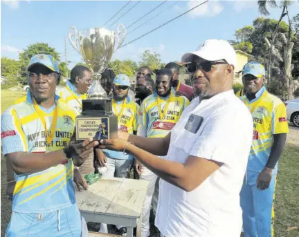  ?? ?? Harrington Costley (right), the chief executive officer of Costley Constructi­on, hands over the championsh­ip trophy to invited team Buff Bay after the Sandals/costley St Mary T20 Big Bash final at Mango Valley Oval in St Mary on Sunday.