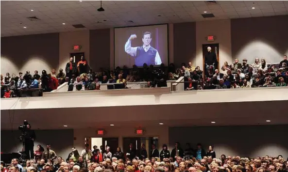  ??  ?? All ears: A crowd listening to Santorum speak at a rally at the First Redeemer Church in Cumming, Georgia. — EPA