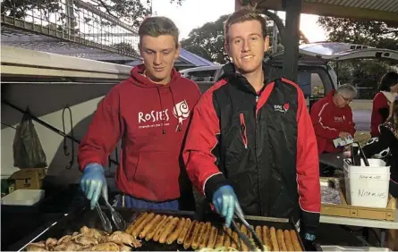  ?? Photo: ?? HELPING OUT: Toowoomba Grammar School students Joe Marshall (left) and Sam Webster help out Rosies Friends on the Street.