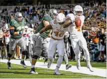  ?? JAY JANNER / AMERICAN-STATESMAN ?? DeShon Elliott (4) returns an intercepti­on for a touchdown against Baylor on Oct. 28. Elliott is planning to bypass the Longhorns’ bowl game and enter the NFL draft.