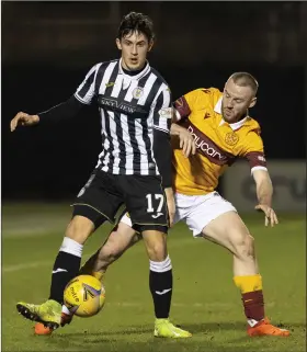  ??  ?? Jamie McGrath, left, and Allan Campbell fight for the ball