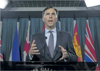  ?? ADRIAN WYLD/THE CANADIAN PRESS ?? Finance Minister Bill Morneau speaks with reporters Thursday on Parliament Hill.