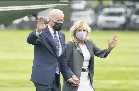  ?? PATRICK SEMANSKY — THE ASSOCIATED PRESS ?? President Joe Biden and first lady Jill Biden wave after stepping off Marine One on the Ellipse near the White House, Monday, May 3in Washington.