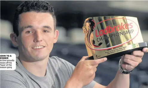  ??  ?? JOHN TO A WINNER McGinn proudly shows off his Player of the Season gong