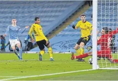  ?? AFP ?? Manchester City’s Phil Foden, left, scores against Borussia Dortmund.