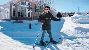  ??  ?? Gérard Ste-Croix snowshoes along Domaine de la Florida’s Cocoa Avenue in March in Quebec’s Saint-Ambroise, Canada.