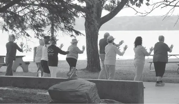  ?? CHERYL BROWNE ?? Tai chi in the park: Adding a social component can make exercise more enjoyable, and community centres often offer a large selection of classes.