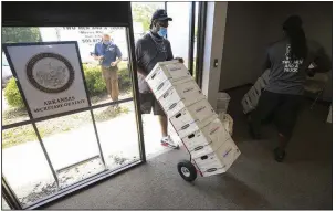  ?? (Arkansas Democrat-Gazette/Staton Breidentha­l) ?? Movers Theo Reed (left) and Joe Mathews unload boxes of signatures from Arkansas Voters First on Monday at the secretary of state’s office in Little Rock. The group is seeking a constituti­onal amendment that would establish an independen­t redistrict­ing commission.