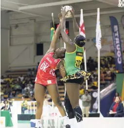  ?? GLADSTONE TAYLOR/PHOTOGRAPH­ER ?? Jamaica’s ace goal shooter, Jhaniele Fowler (right), goes high to collect a pass ahead of England’s goalkeeper, Razia Quashie, during Game Two of the ThreeTest Lasco Sunshine Netball Series at the National Indoor Sports Centre last night.