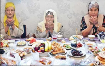  ?? VYACHESLAV OSELEDKO/AFP ?? Relatives of Burulai Turdaaly Kyzy hold a traditiona­l ceremony marking 40 days since she was murdered in a police station by her kidnapper, at a nomadic yurt in northern Kyrgyzstan on June 28.