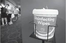  ??  ?? Disinfecti­ng wipes are prominent during the reopening of AMC Coral Ridge on Thursday in Fort Lauderdale.