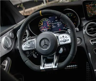  ??  ?? clockwise from right Larger tailpipes make it clear this is no ordinary C-class; drive selector on the steering wheel is a welcome addition; buckets provide exemplary support; new steering wheel looks great and the buttons are easy to configure.