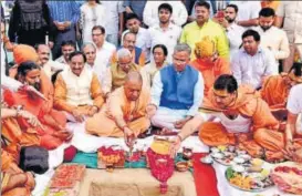  ?? HT PHOTO ?? ▪ UP CM Yogi Adityanath lays the foundation stone for a state guest house in Haridwar on Monday as TS Rawat looks.