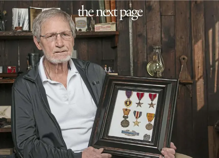  ?? Pittsburgh Post-Gazette ?? Vietnam veteran Frank "Mike" Hepler, 72, at his home on Jan. 21, displays medals from his military service in Vietnam. Mr. Hepler, who retired as president and CEO of the Boys & Girls Clubs of Western Pennsylvan­ia, served in the U.S. Army's 1st Squadron, 1st Cavalry Regiment, in Vietnam in 1967 and ’68. Among his awards are the Silver Star and two Bronze stars.