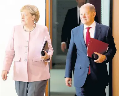  ?? AP ?? In this Thursday, June 6 photo, German Chancellor Angela Merkel and German Finance Minister and Vice-Chancellor Olaf Scholz arrive for the weekly cabinet meeting at the chanceller­y in Berlin, Germany.