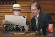  ?? JOHN HANNA — THE ASSOCIATED PRESS ?? Kansas state Reps. Brenda Landwehr, left, R-Wichita, and Steve Huebert, R-Valley Center, confer during a meeting of a House committee on redistrict­ing at the Statehouse in Topeka, Kan.