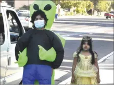  ?? PHOTO TOM BODUS ?? Cancer survivor Andre Calihua, 13, and his sister Tanya, 7, were among the guests at the Halloween drive-thru event Friday at Cancer Resource Center of the Desert.