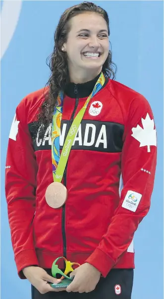  ?? JEAN LEVAC ?? Bronze medallist Kylie Masse of LaSalle, Ont., poses on the podium with her medal after finishing in a tie for third in the women’s 100-metre backstroke final Monday at the Summer Olympics in Rio de Janeiro.