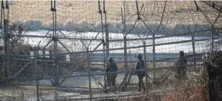  ?? - Reuters file photo ?? PATROLLING: South Korean soldiers patrol along a barbed-wire fence near the demilitari­zed zone separating the two Koreas in Paju, South Korea.