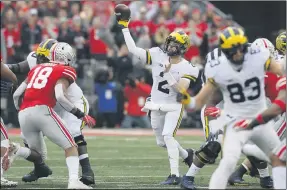  ?? JAY LAPRETE — THE ASSOCIATED PRESS ?? Michigan quarterbac­k Shea Patterson throws a pass against Ohio State during an NCAA college football game in Columbus on Nov. 24, 2018. Magistrate Judge Norah McCann King moved a change of plea hearing from June 18to July 1, for Daniel Rippy. Rippy is accused of making an “electronic communicat­ion” threat from California by threatenin­g a shooting and vowing to hurt players on the football team.