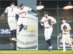  ?? Associated Press ?? Astros shortstop Carlos Correa (1), outfielder George Springer (4), outfielder Jake Marisnick (6) and Myles Straw (26) celebrate the win in Game 2 Saturday.