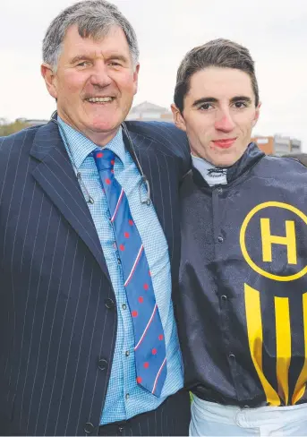  ?? INQUIRIES: Trainer John Sadler poses with son Tom Sadler at Caulfield racecourse. ??