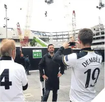  ??  ?? Fans pose outside Spurs’ new stadium.