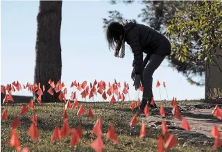  ?? OTTO KITSINGER THE ASSOCIATED PRESS ?? Cindy Pollock began planting tiny flags across her yard in Boise, Idaho — one for each of the more than 1,800 Idahoans killed by COVID-19.