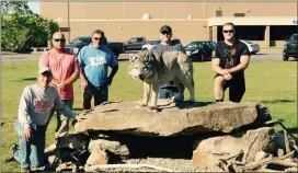  ?? Photo by Keith Reigel ?? Pictured with the beautiful wolf statue at the entrance of Kane Area High School are Jim Siriann, Dan Madigan, Al Detsch, Kris Hulings and Austin Hulings.