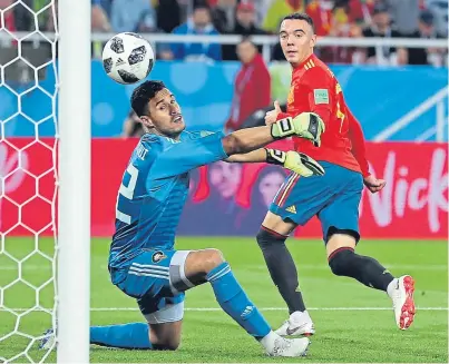  ?? Picture: Getty Images. ?? Iago Aspas flicks the ball past Morocco keeper Monir El Kajoui for Spain’s late equaliser.