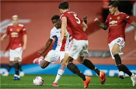  ?? — AFP ?? Deadly strike: Crystal Palace’s Wilfried Zaha shoots to score the third goal against Manchester United during the English Premier League match at Old Trafford.