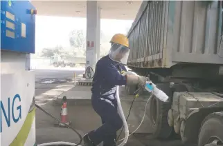  ??  ?? A WORKER prepares to fuel liquefied natural gas (LNG) for an LNG truck at a gas station in Yutian county, China’s Hebei province, Sept. 29.