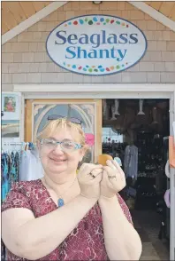  ?? DAVE STEWART/THE GUARDIAN ?? Patricia McLean-Ettinger, who runs P.E.I. Seaglass Shanty on the Souris boardwalk, says there’s no better place in P.E.I. to find seaglass than along Souris Beach. But it’s also becoming known for a more troubling issue, broken glass which she says is...